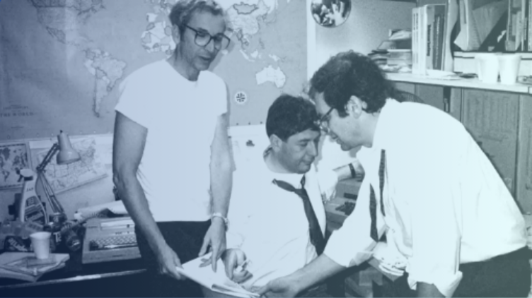 3 people at work discussing a document