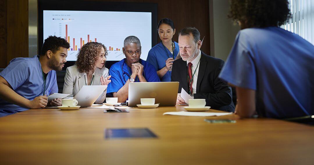 Group of people looking at laptop
